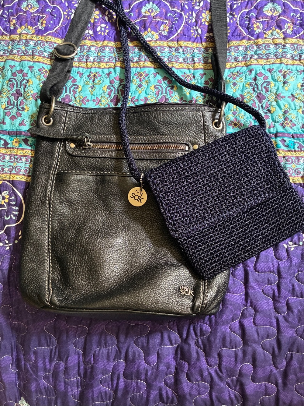 The Sak Black Leather Crossbody with Navy Mini Crossbody Crochet Pouch.